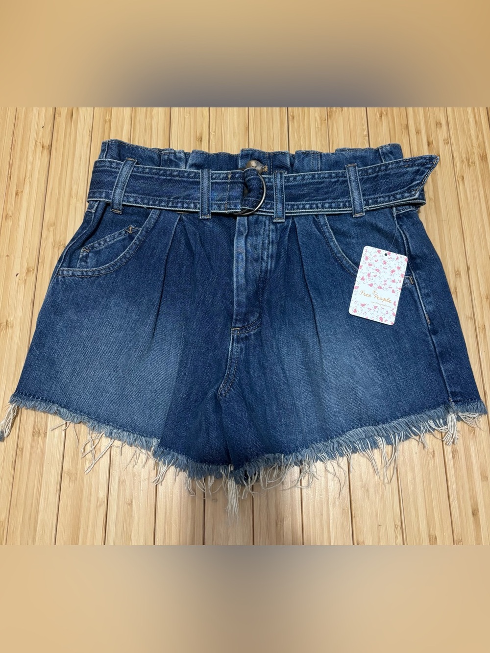 Free People size XS denim shorts. NWT.  Paperbag waist and a raw frayed hem.